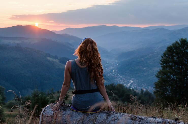girl-sits-edge-cliff-looking-sun-valley-mountains-woman-sitting-mountain-top-contemplating-sun...jpg