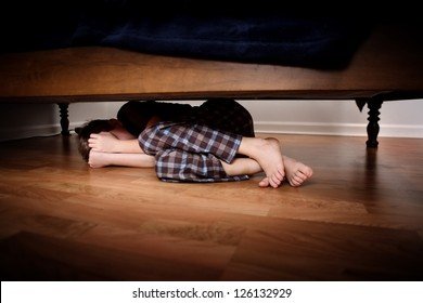 fearful-boy-hiding-under-bed-260nw-126132929.jpg