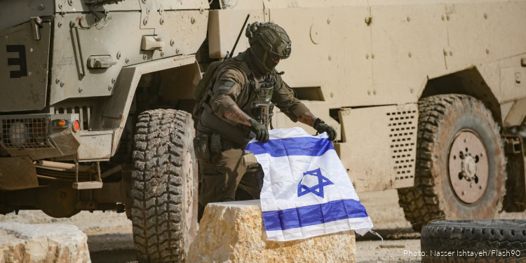 Israeli soldiers stand guard during a protest by Palestinians who were evacuated by the IDF from their homes in the Nur Shams refugee camp in Tulkarem, in the West Bank, on December 15, 2025.