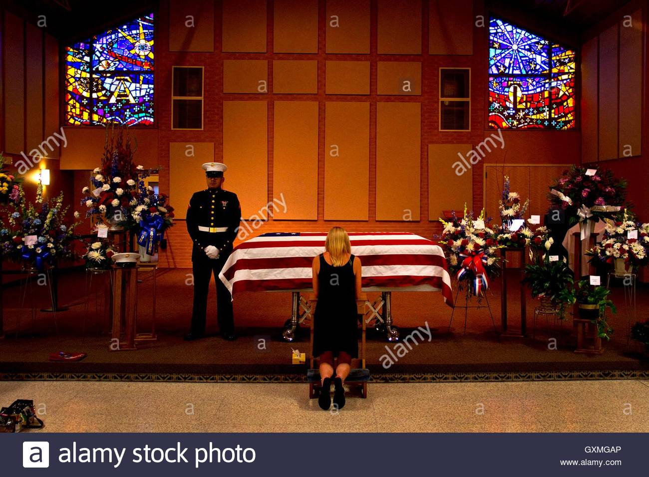 abby-cuttell-kneels-in-front-of-the-flag-covered-casket-and-says-goodbye-GXMGAP.jpg