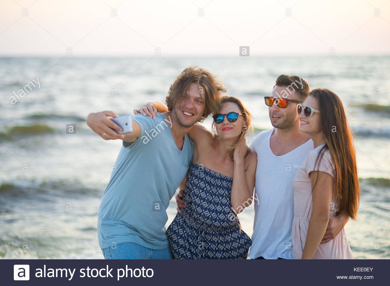 group-of-cheerful-young-people-photographed-on-the-beach-two-guys-KEE0EY.jpg