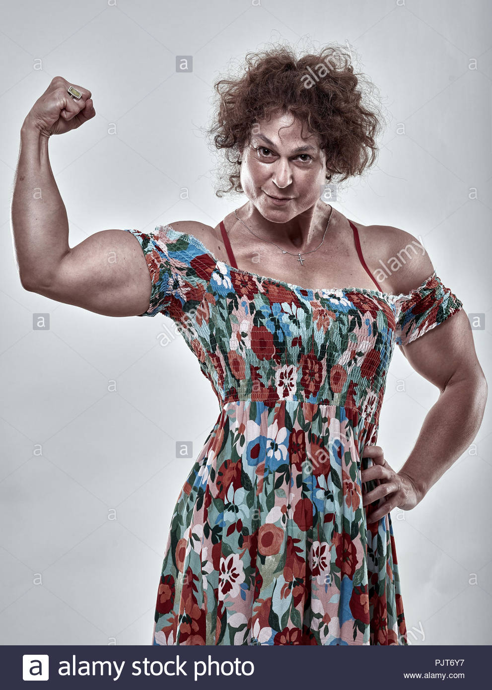 girls-power-metaphor-with-muscular-mature-woman-flexing-biceps-PJT6Y7.jpg