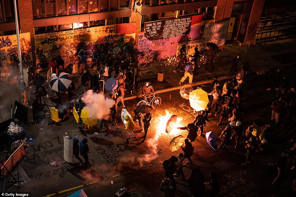 29459696-8409067-Demonstrators_clash_with_police_near_the_Seattle_Police_Departme-a-5_1591856568914.jpg
