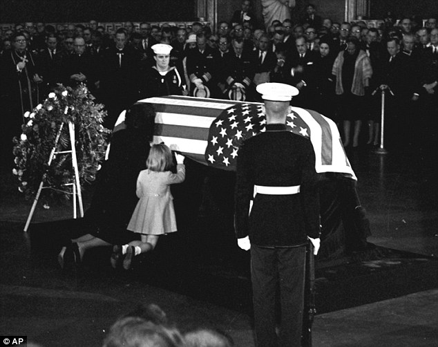 Grady Thompson stands to attention (pictured front right with his back to the camera) alongside John F Kennedy's coffin as his widow, Jacqueline, and daughter Caroline kneel alongside in the U.S. Capitol Rotunda in 1963