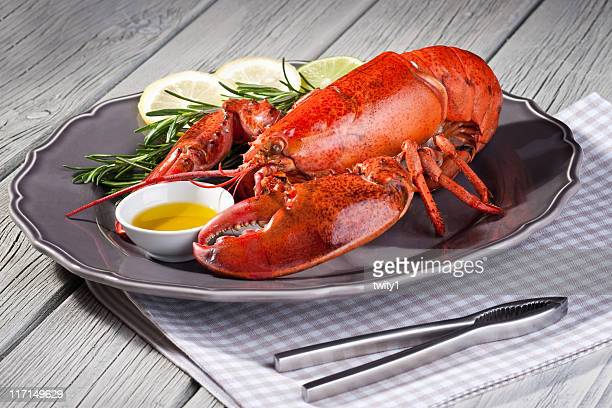 close-up-of-fresh-steamed-lobster-with-herbs-in-grey-plate-picture-id117149629