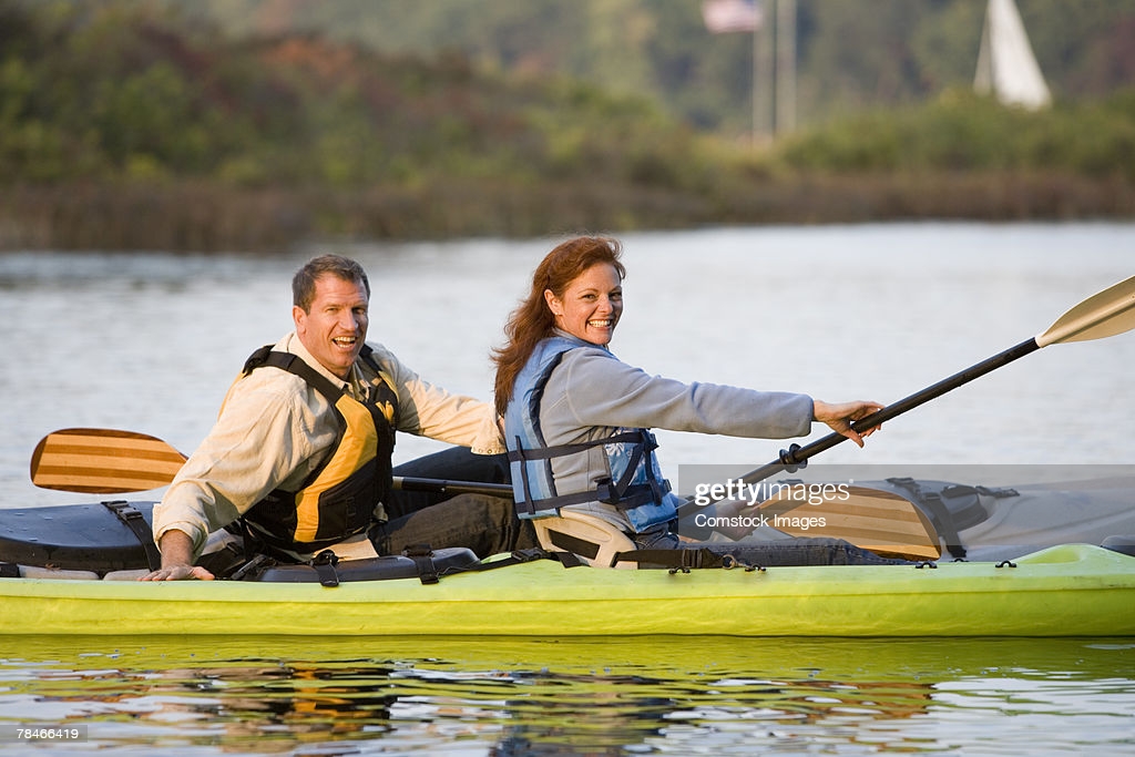 man-and-woman-kayaking-picture-id78466419