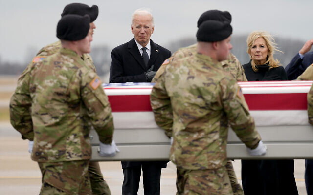 US President Joe Biden, third left, and first lady Jill Biden, right, stand as an Army carry team moves the transfer case containing the remains of US Army Sgt. Kennedy Ladon Sanders at Dover Air Force Base, Delaware, February 2, 2024. (AP Photo/Matt Rourke)